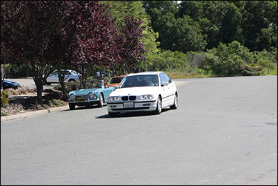 white bmw leaving checkpoint